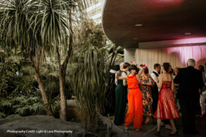Wedding Party with out door indoor feel dure to the botanical garden. wedding guesting dancing and enjoying the night